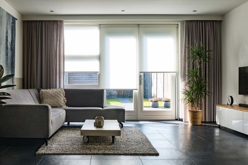 Free A modern living room with sleek furniture, natural light, and minimalist decor. Stock Photo