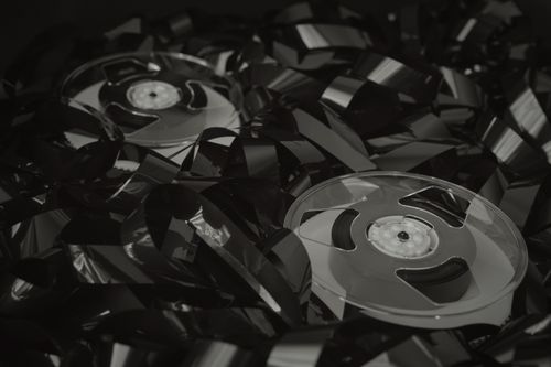 Free High-angle view of vintage cassette tapes with tangled recording tape, emphasizing a retro aesthetic. Stock Photo