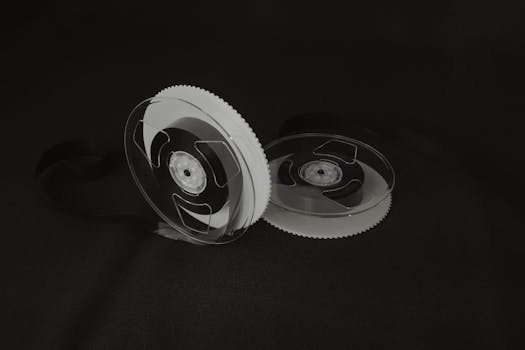 Close-up of vintage cassette tape reels on a black background, illustrating nostalgia and retro vibes.