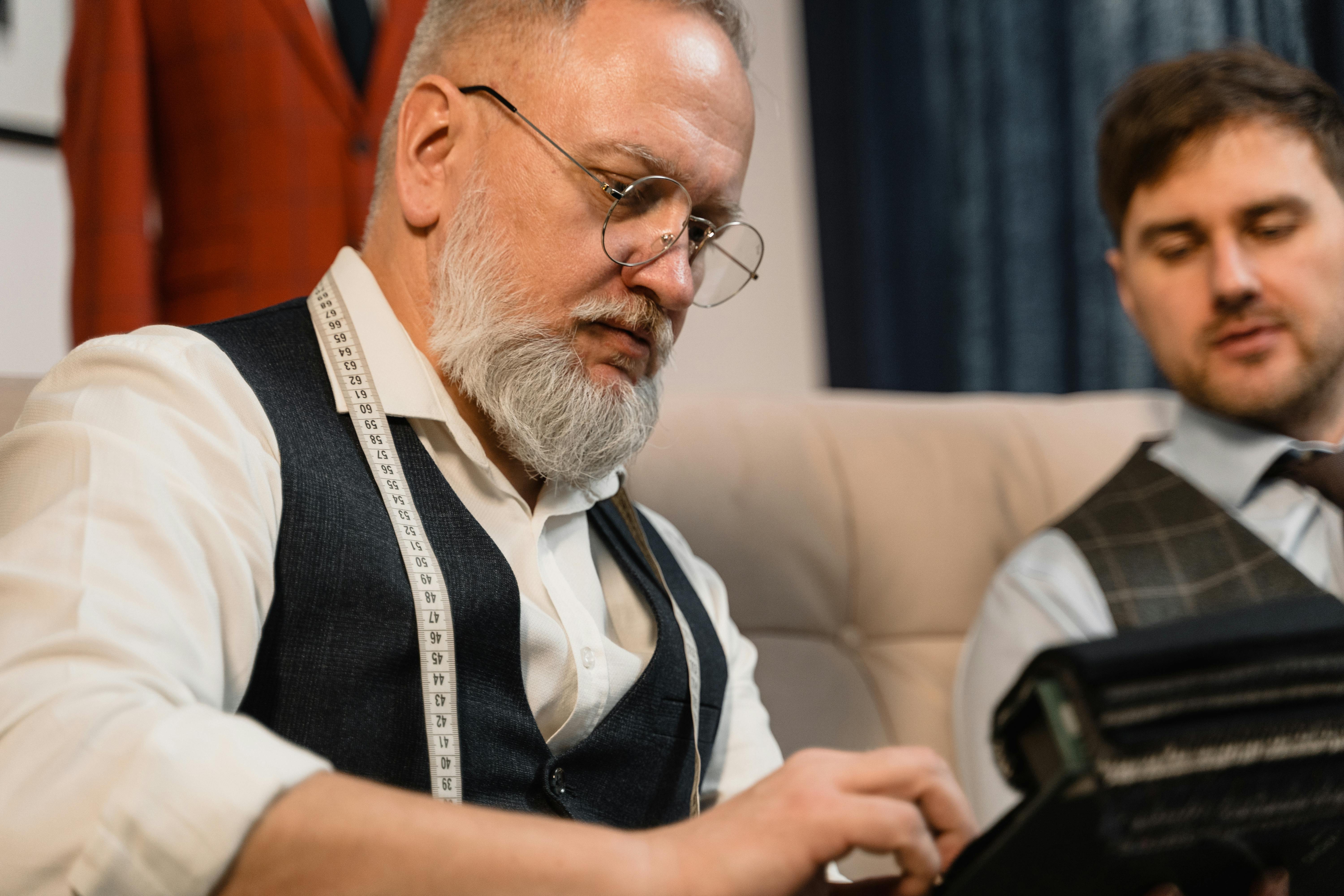 man in black vest and white dress shirt wearing eyeglasses