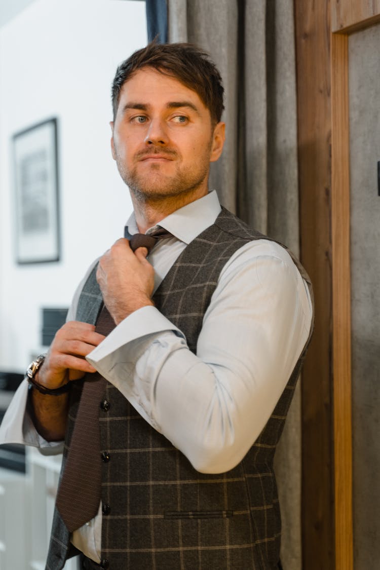 A Man In White Long Sleeves And Brown Necktie