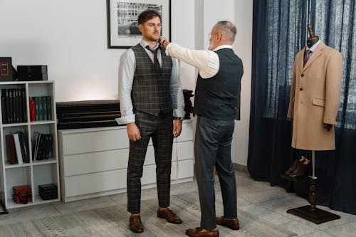 A Man Measuring His Client's Shoulder