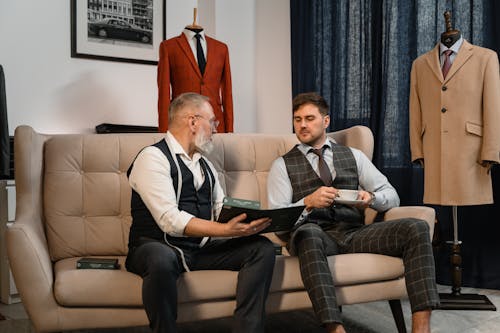 Man in Black Vest Sitting on Beige Sofa