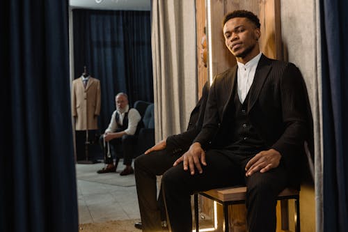 
A Tailor and a Client in a Workshop