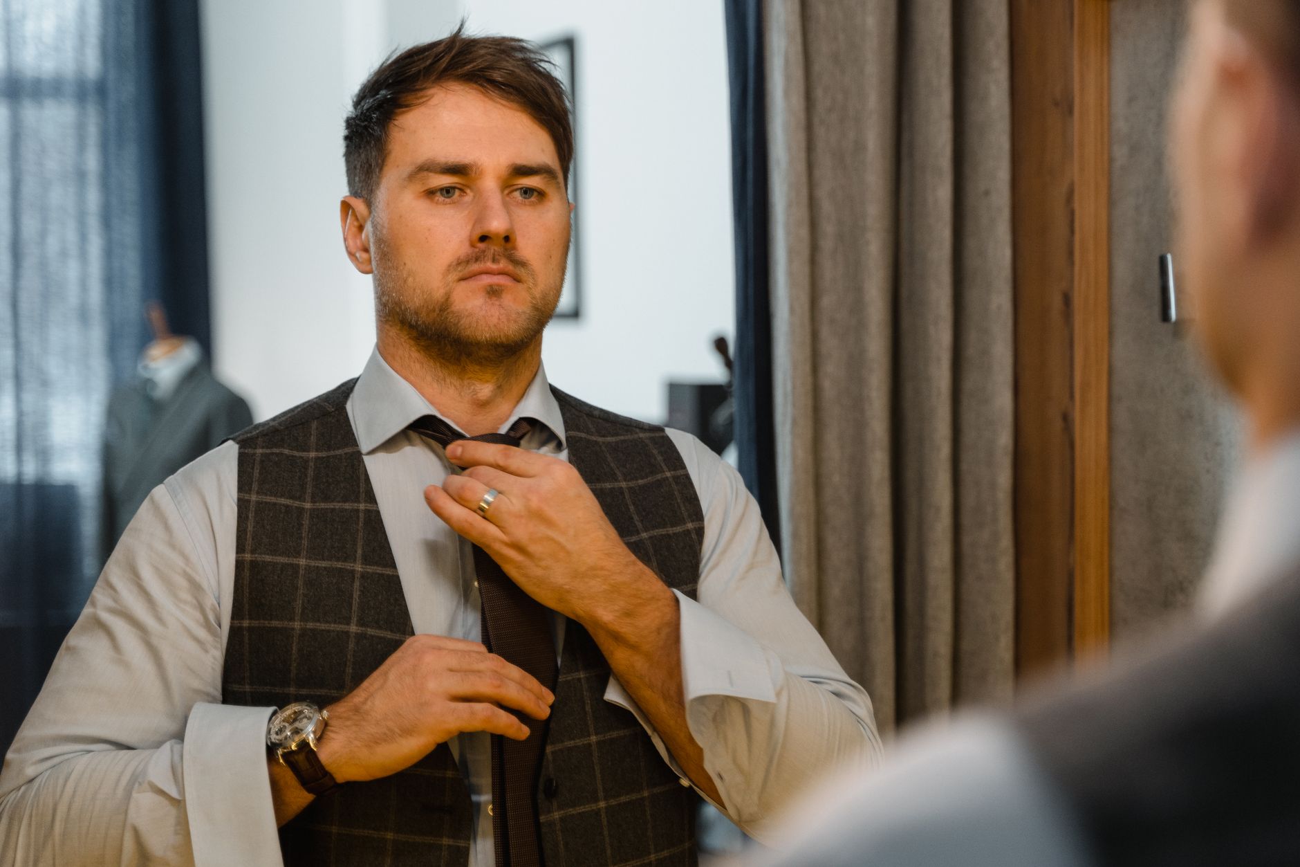 man checking outfit mirror Malaysian office