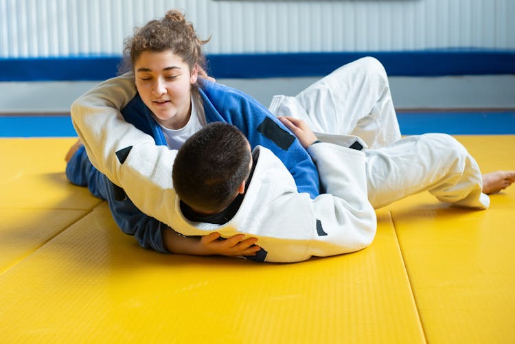 Woman And Man Practicing Judo