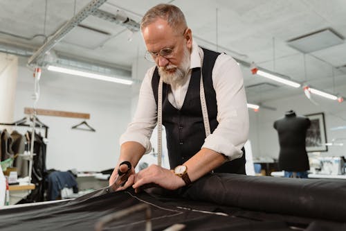 A Tailor Man Cutting Fabric
