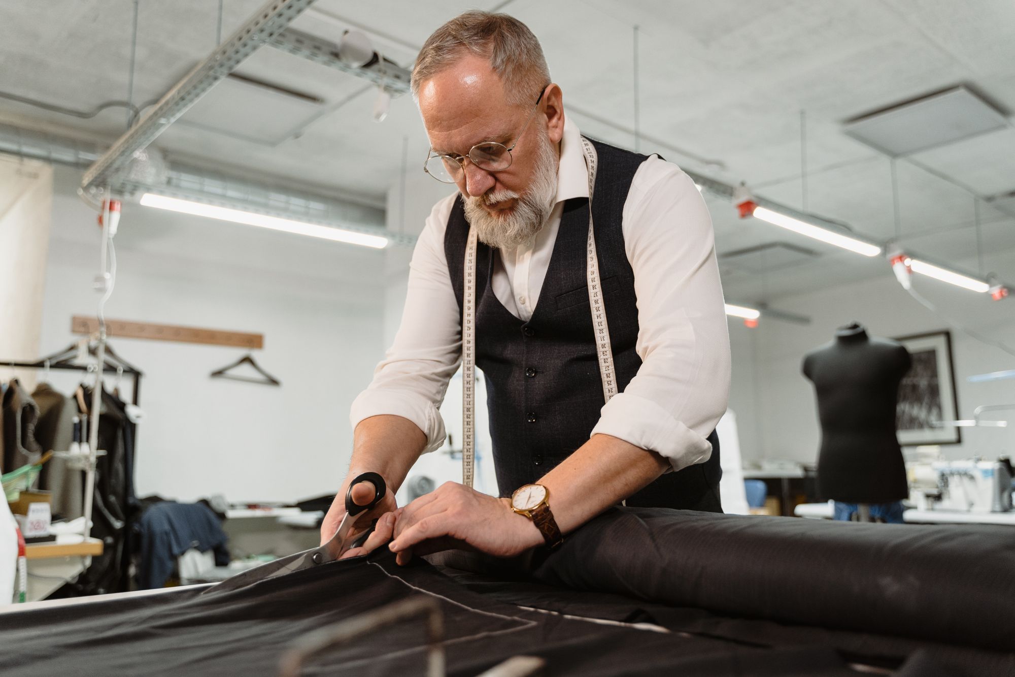 A tailor cutting cloth with shears