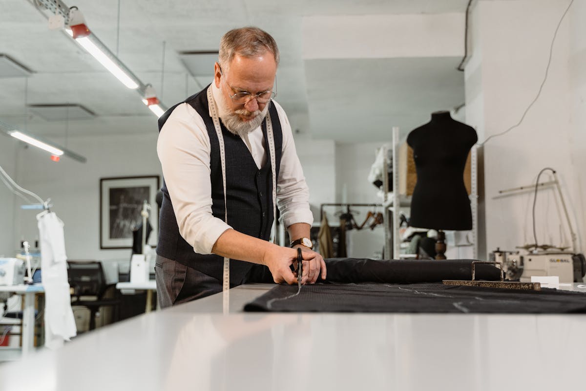 Person wearing headphones while typing on a laptop in a cozy environment