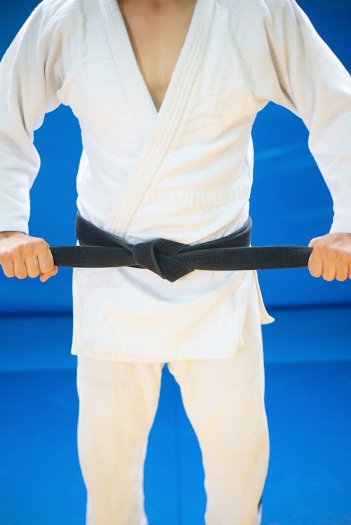 Free A Person wearing Judo Uniform holding his Black Belt Stock Photo