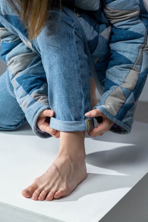 Free Person Folding Her Pants Stock Photo
