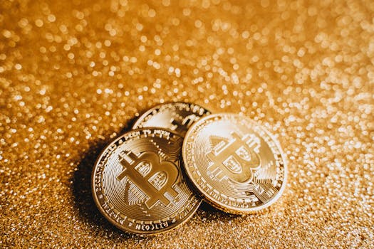 Close-up of gold Bitcoin coins on a glittery surface, symbolizing digital finance and cryptocurrency investment.