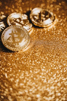 Close-up of bitcoin coins on a shimmering gold surface symbolizing cryptocurrency investment.