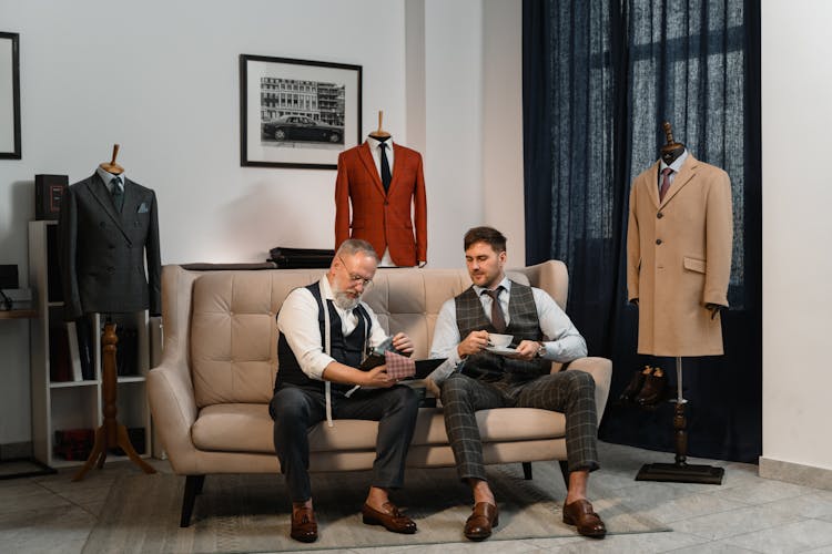 Men In Suits Sitting On A Couch