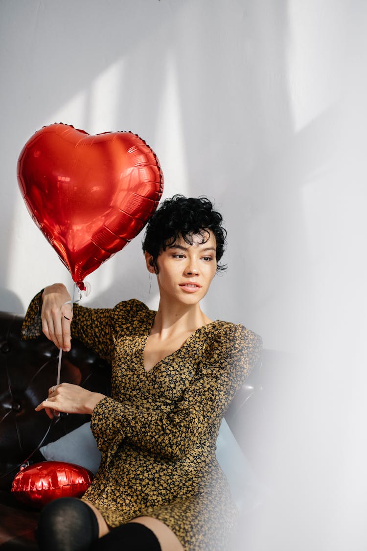 Young Woman With Bright Red Heart Shaped Balloon