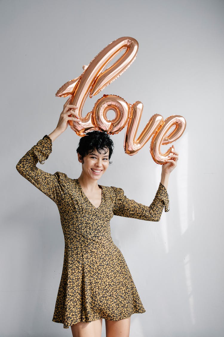 Happy Woman Showing Love Shaped Balloon