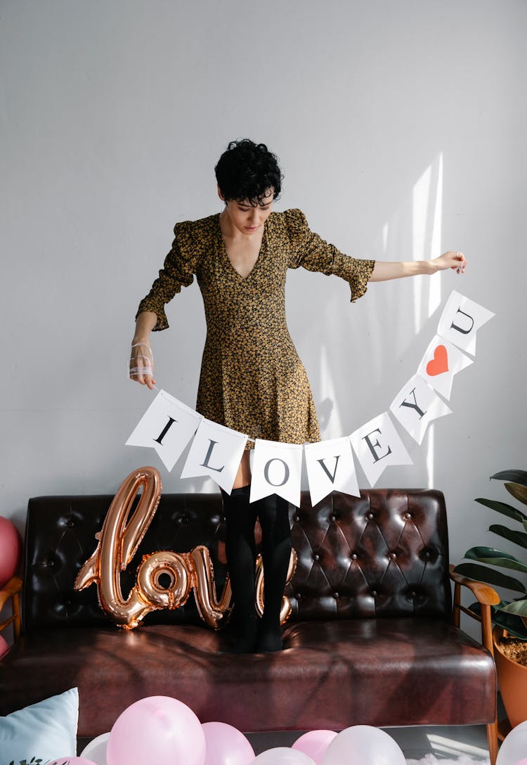 Serious Woman Standing With I Love You Flag Garland