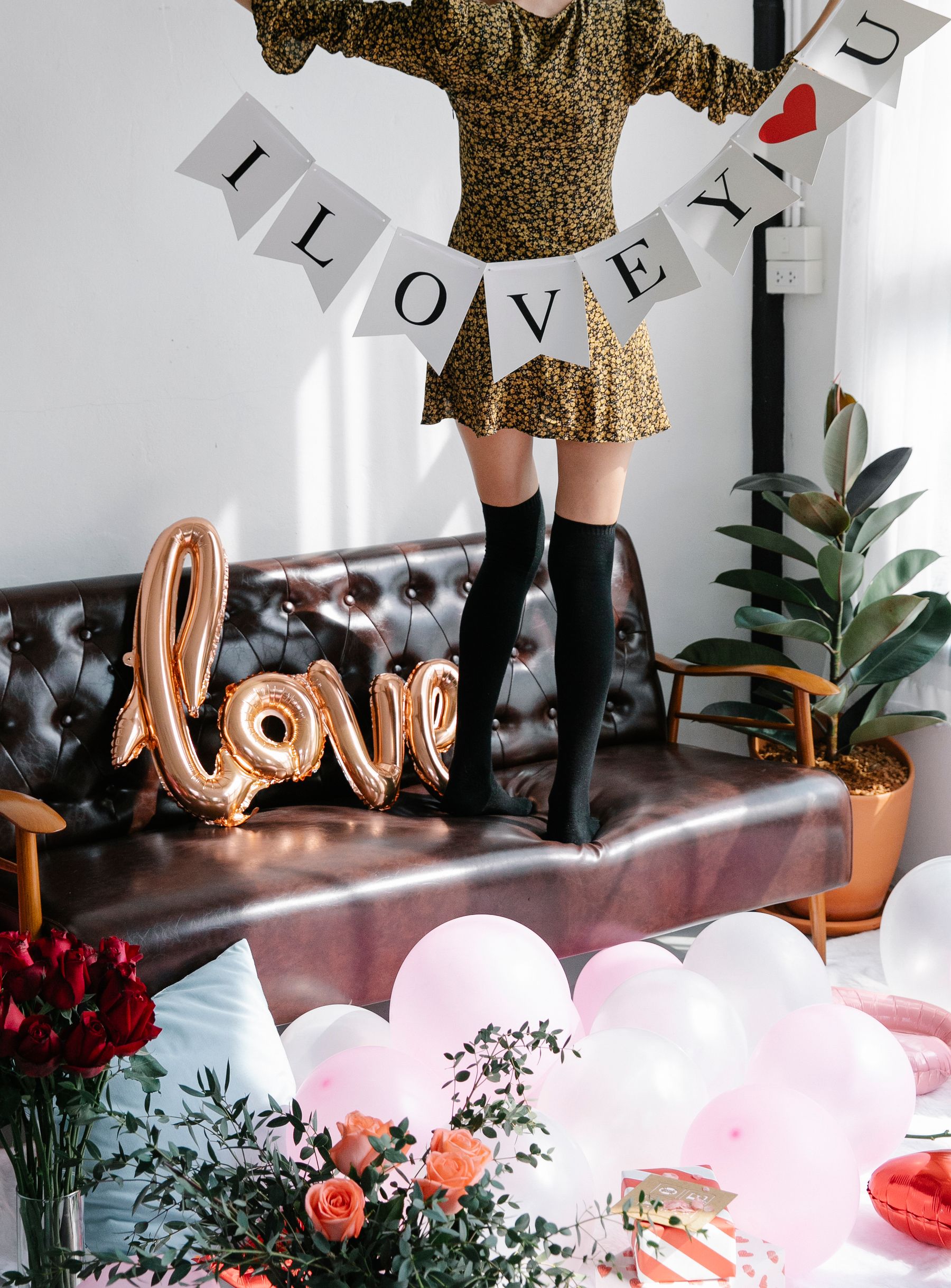 Living room decorated for Valentine's Day with balloons and lettering