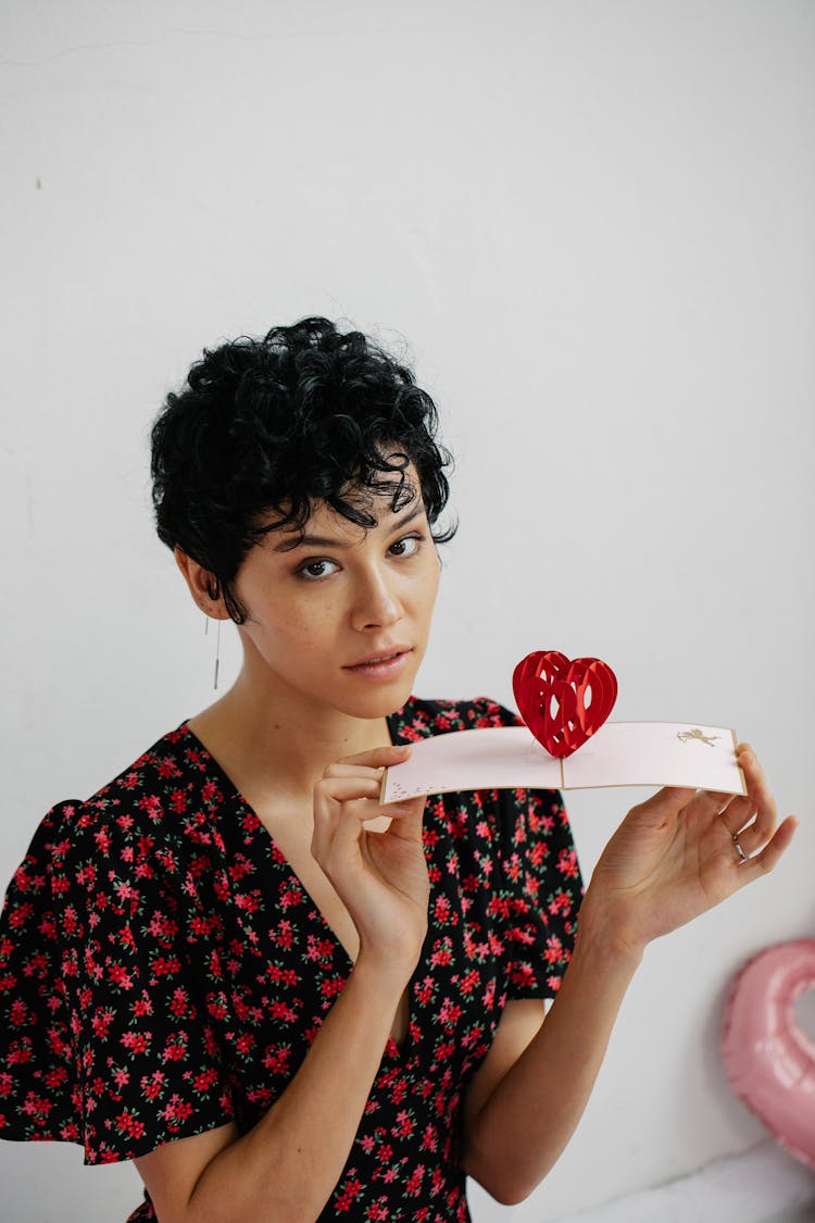 Woman Holding A Card With Heart Shape Pop-up