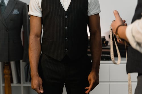 A Man Wearing a Black Vest over a White Short