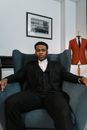 Man in Black Suit Sitting on Armchair Sofa