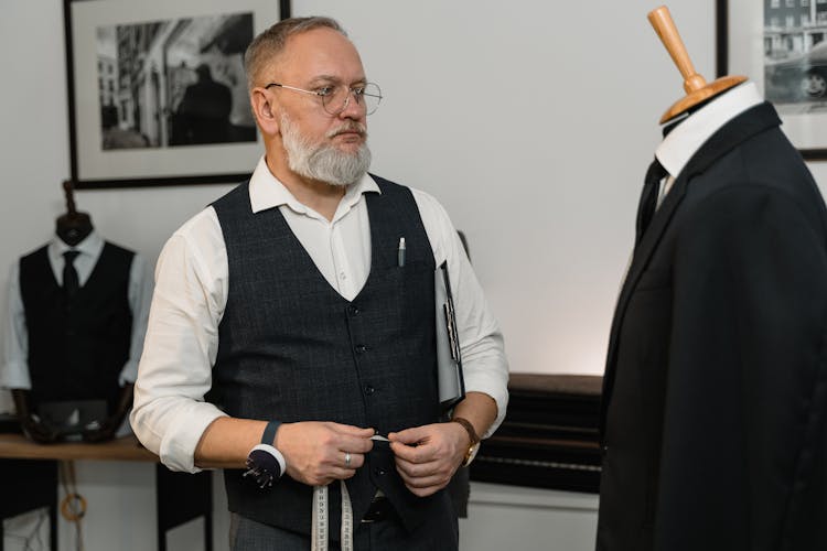 A Tailor Looking At A Business Suit