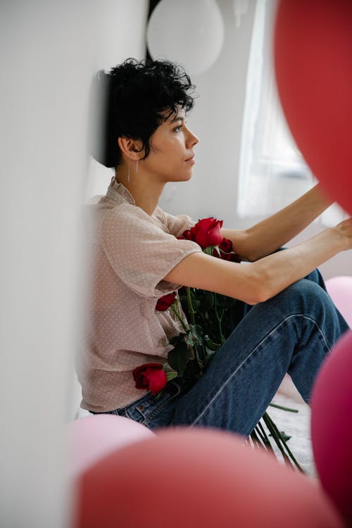 Attractive woman sitting with flowers