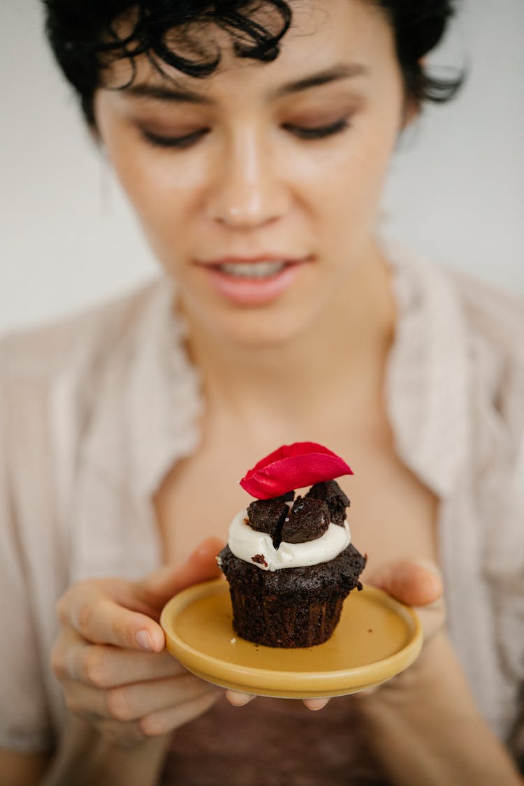 Hungry Young Ethnic Woman Holding Plate With Yummy Chocolate Cupcake