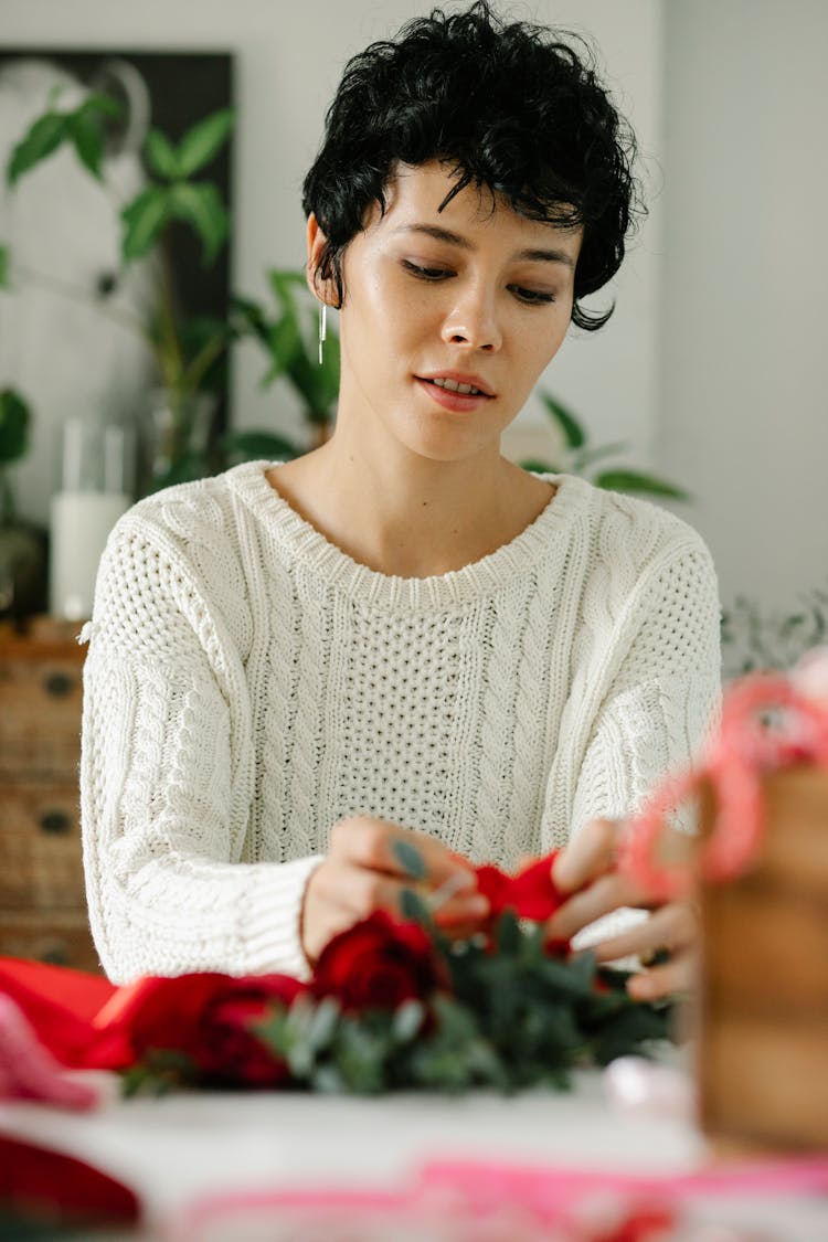 Young Ethnic Woman Tying Bow On Bunch Of Fresh Roses