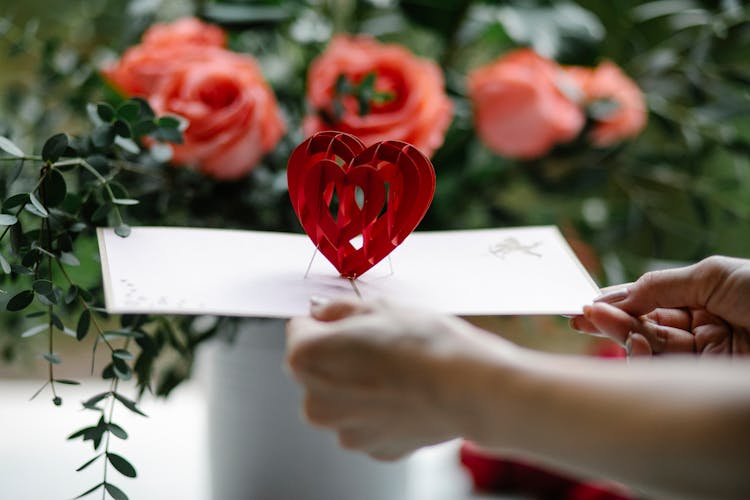 Crop Woman Showing Pop Up Gift Card With Decorative Heart