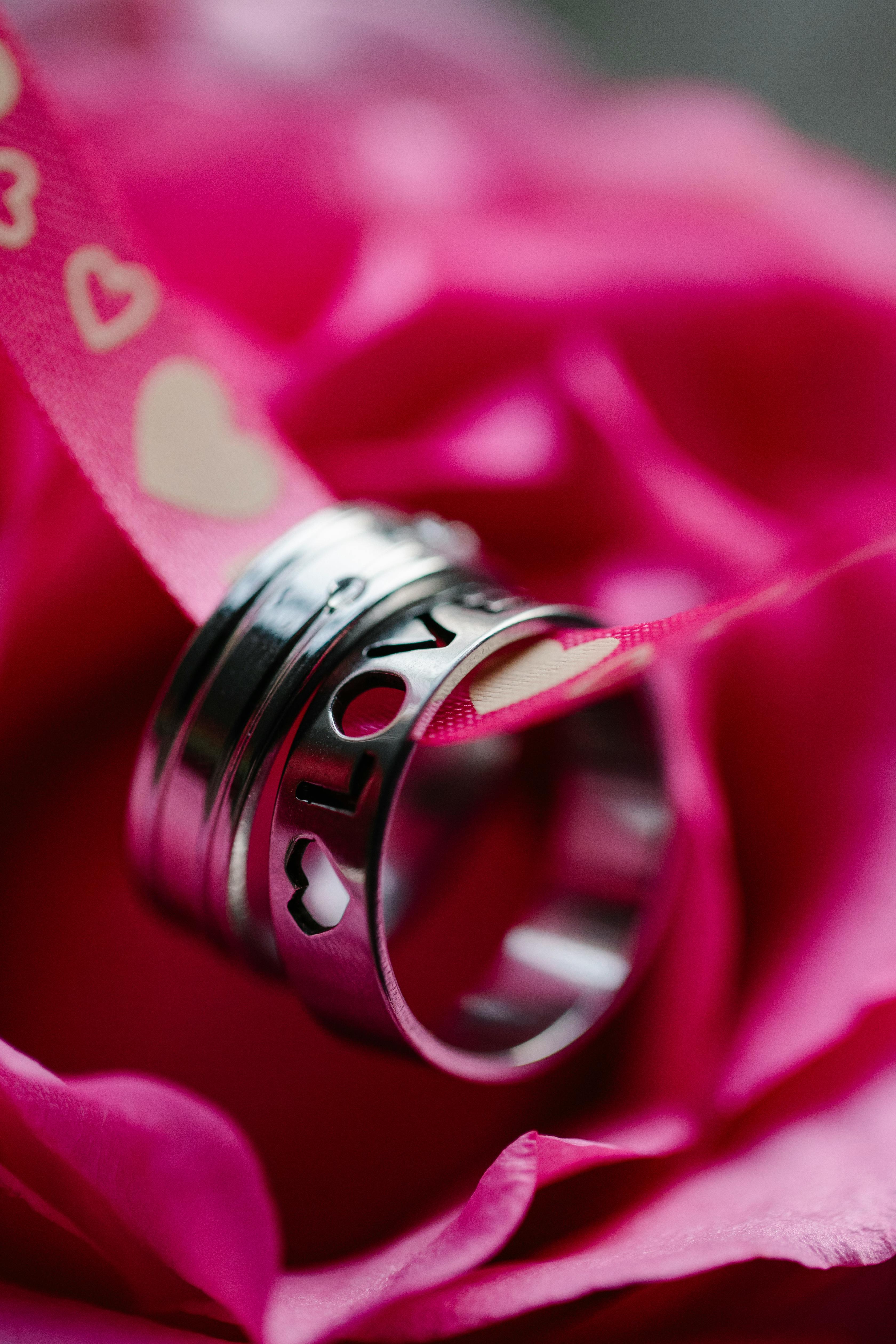 silver rings on pink flower