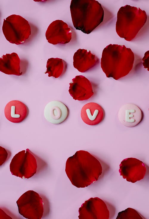 Free Love inscription among rose petals Stock Photo