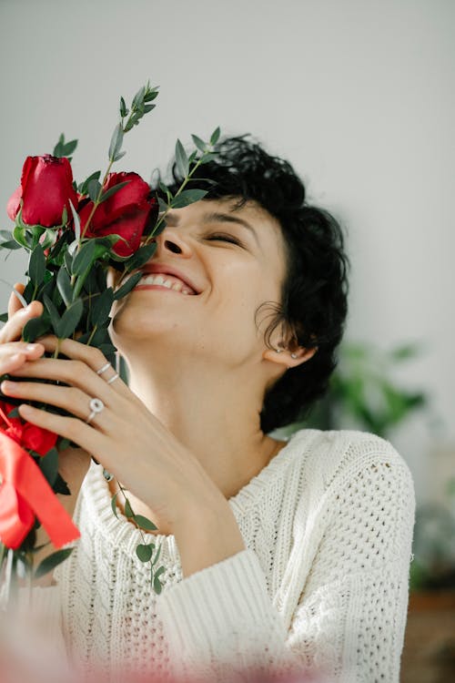 Joyful woman with bouquet of roses