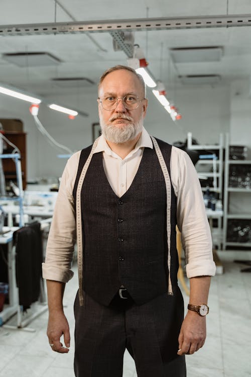 Man in Black Vest and White Dress Shirt with Tape Measure on Shoulder