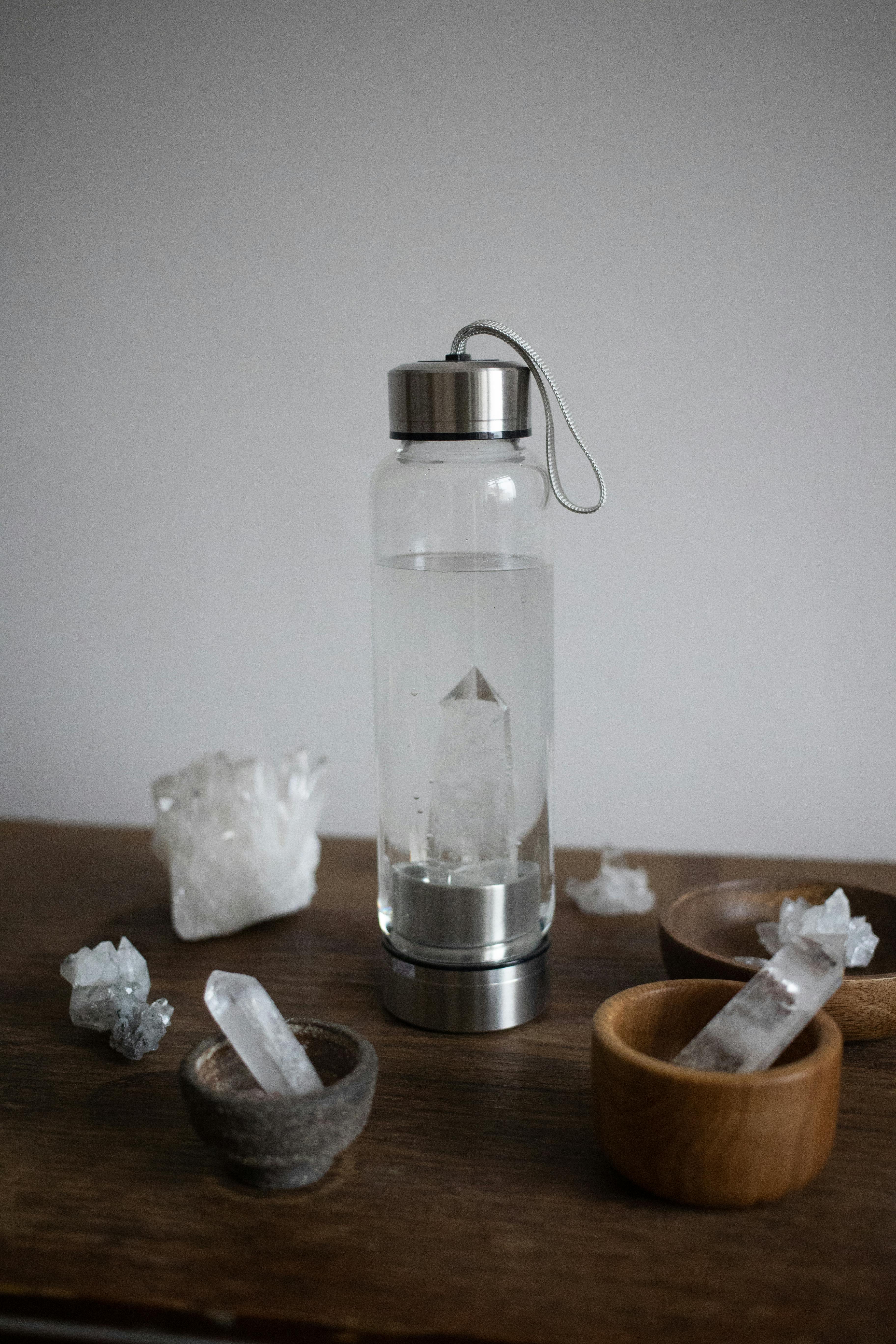 clear glass bottle on brown wooden table