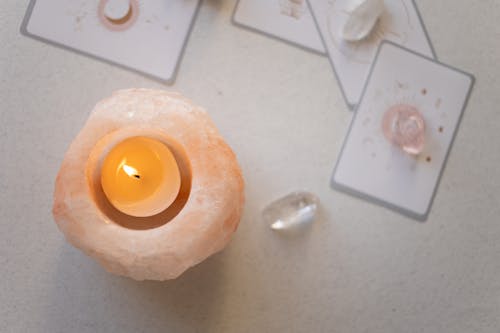 Free Tealight on a Himalayan Salt Candle Holder Stock Photo