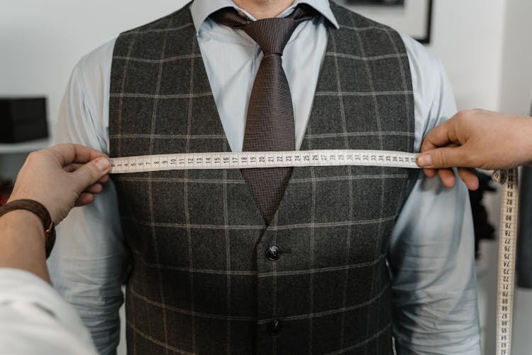 Tailor Measuring A Client's Chest