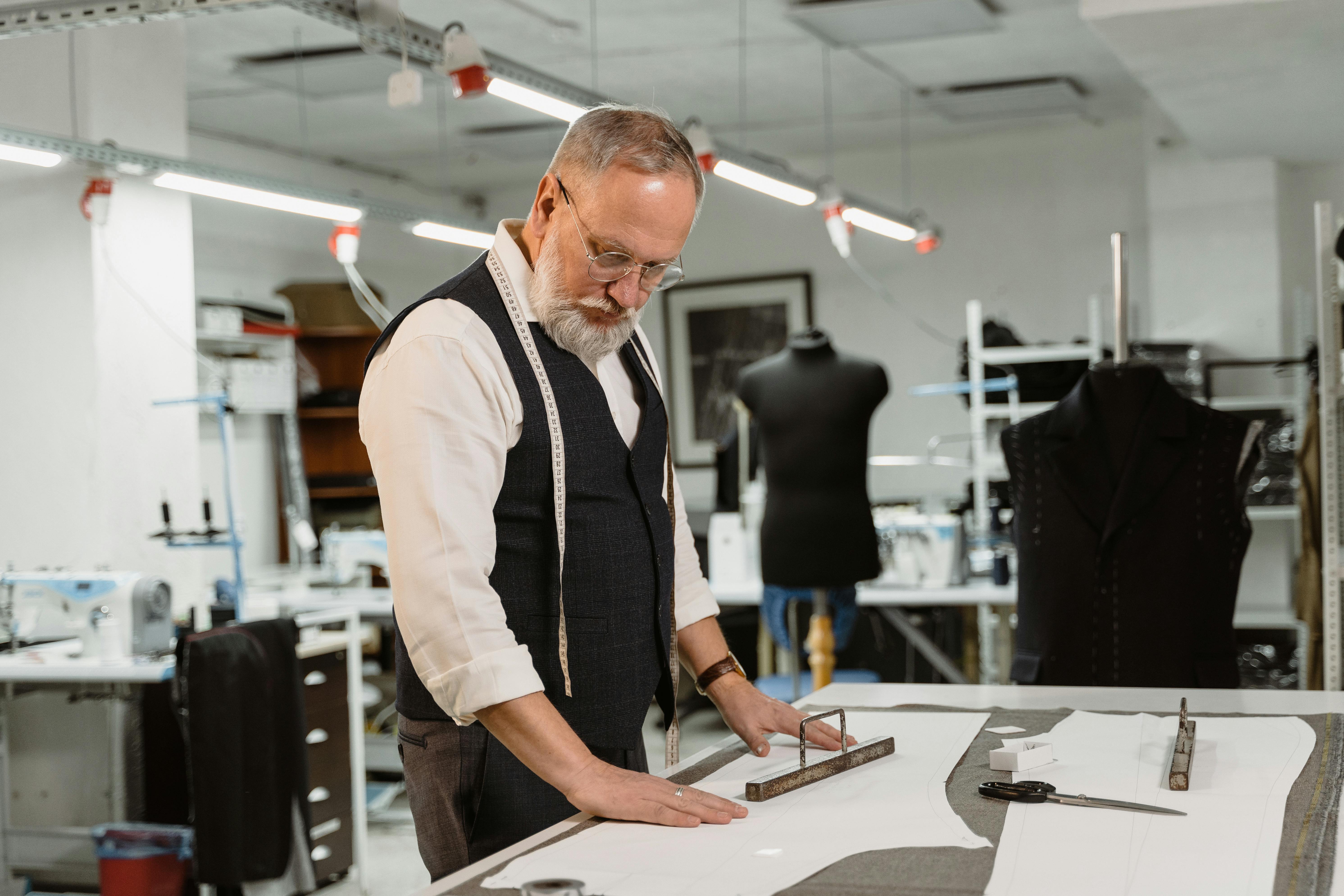 man in black vest and white dress shirt holding white paper