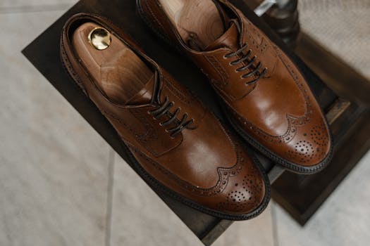 Close-up of luxurious brown leather Oxford shoes with perforated design.
