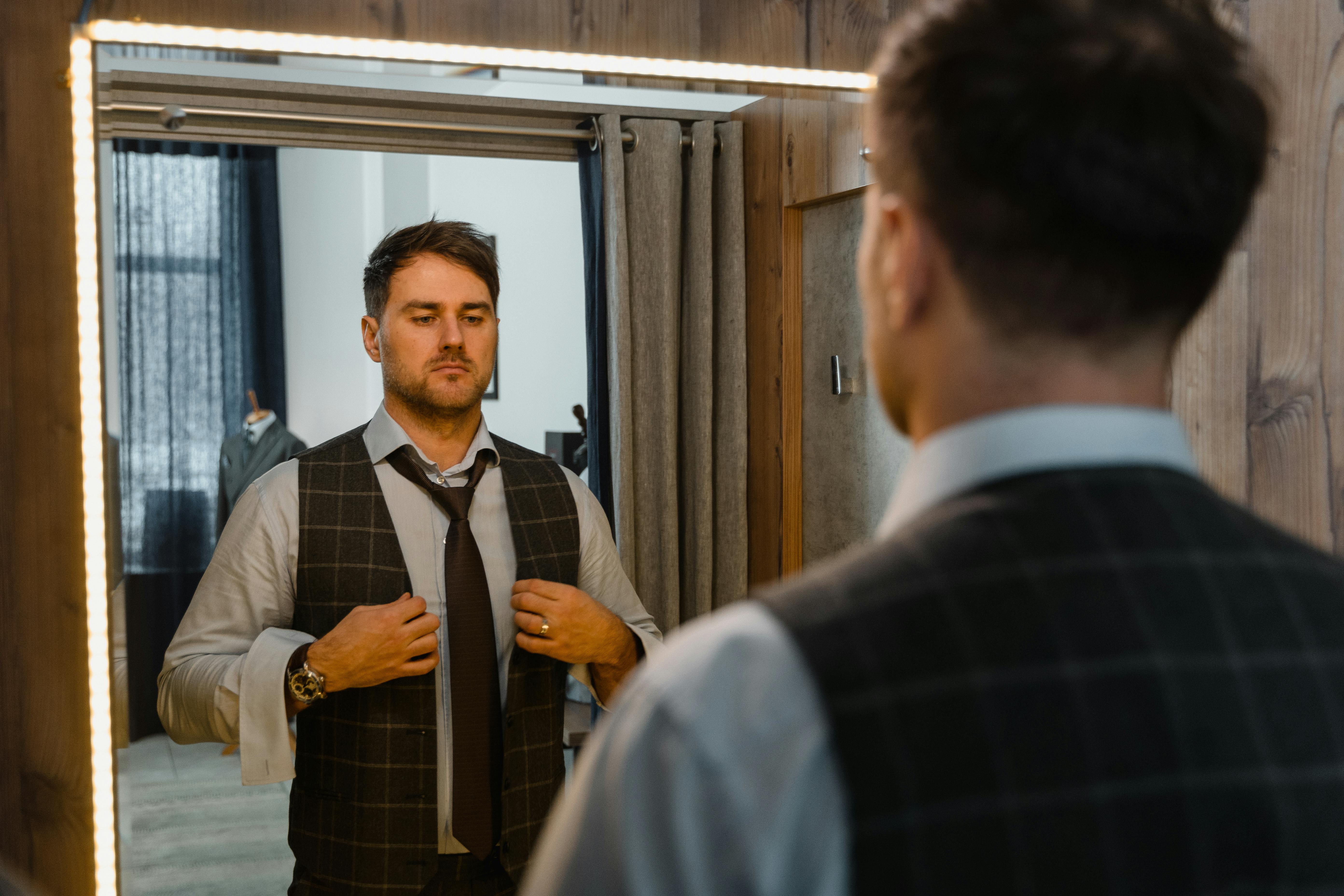 2 men in suit standing near window