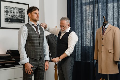 Man in Black Vest and White Long Sleeve Shirt Taking Man's Body Measurement