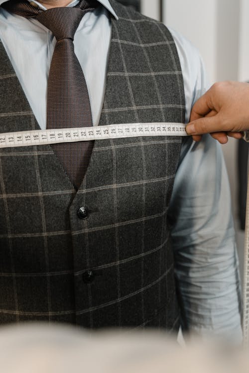 Person Holding Gray and White Tape Measure