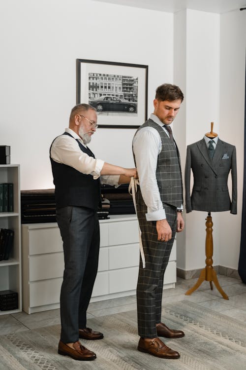 A Tailor Measuring a Client Using a Tape Measure