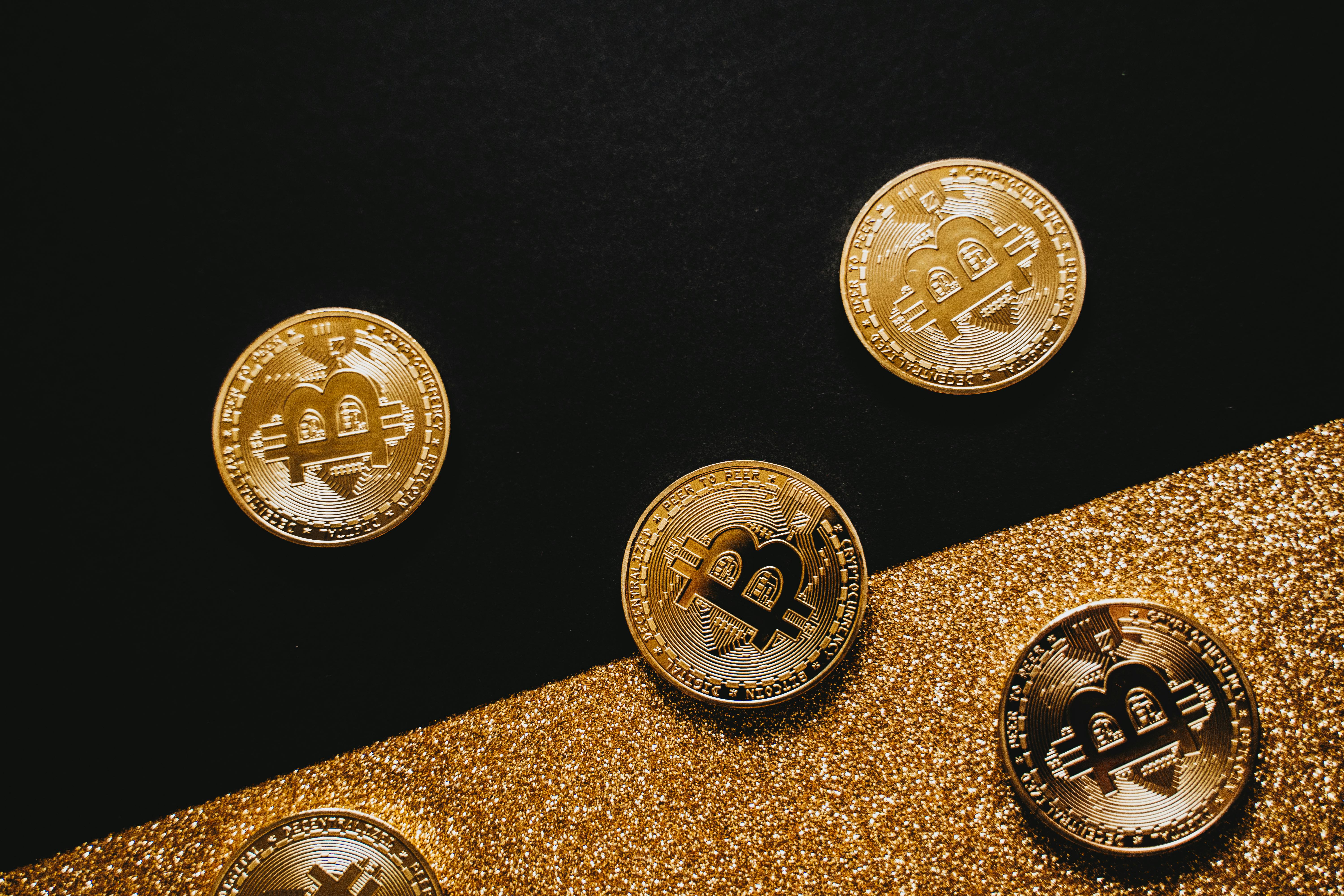 gold bitcoins on black surface