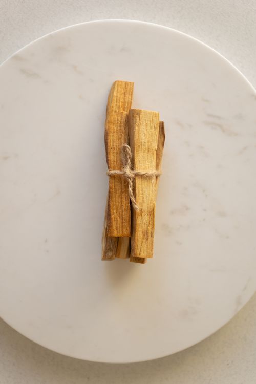 Free Close-up of cinnamon sticks tied with string on a white marble plate. Stock Photo