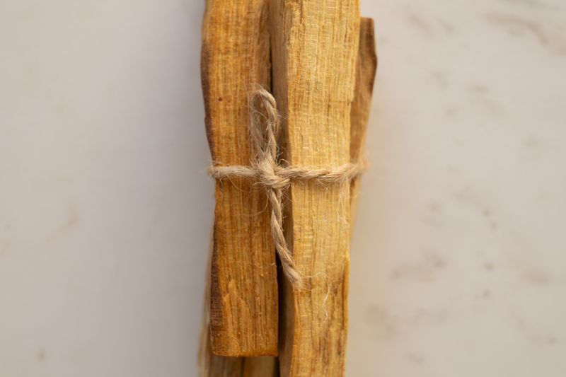 Bundle of palo santo sticks arranged on a marble surface