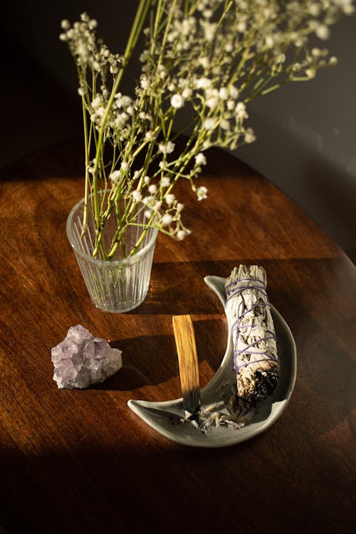 Bundle of White Sage Next to Herbs in Vase