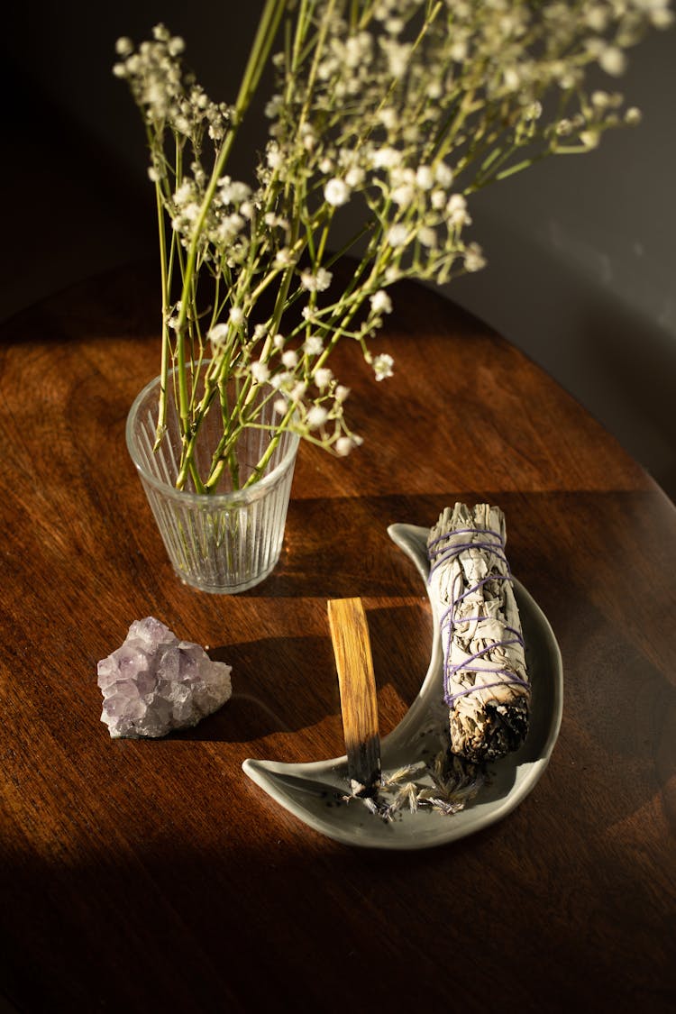 Bundle Of White Sage Next To Herbs In Vase