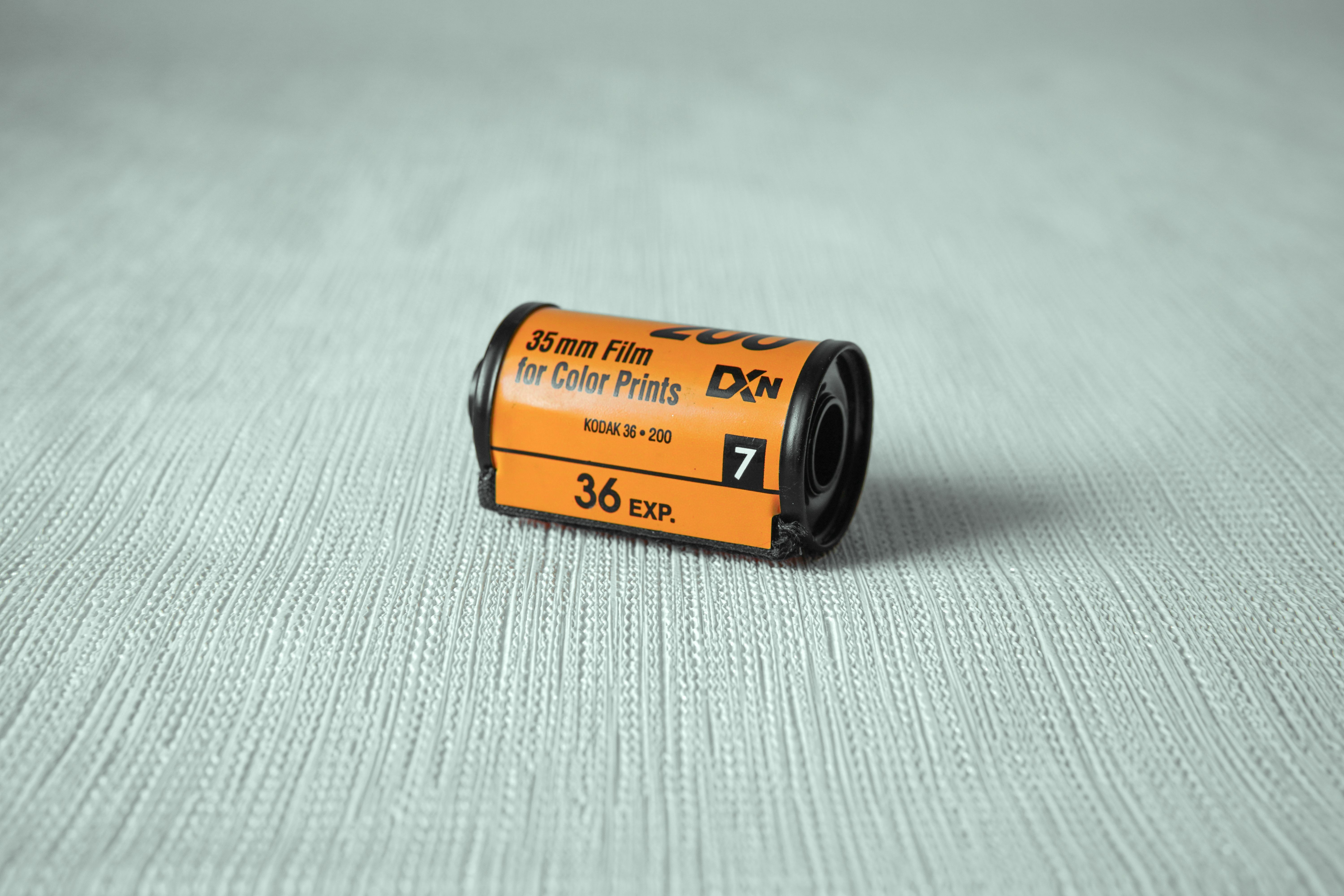 Close-up of a classic 35mm film roll for color prints with intricate surface texture background.