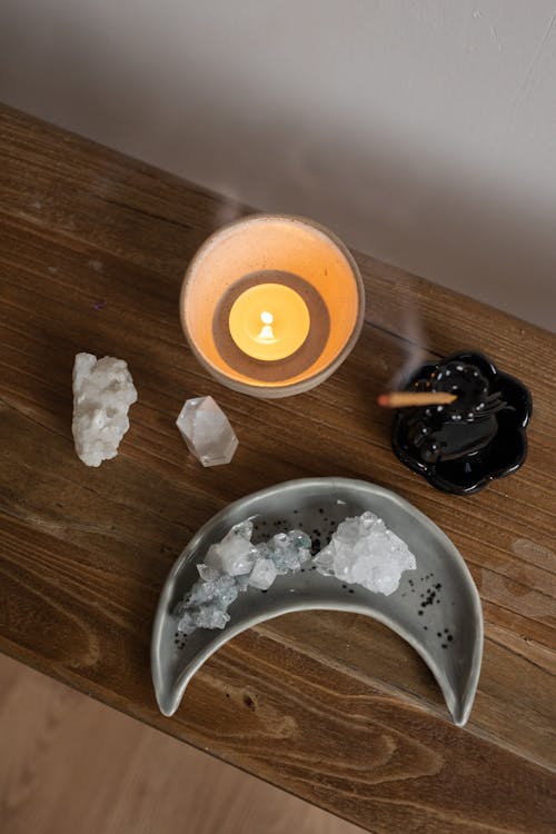 Crystals, Burning Candle and an Incense Stick 